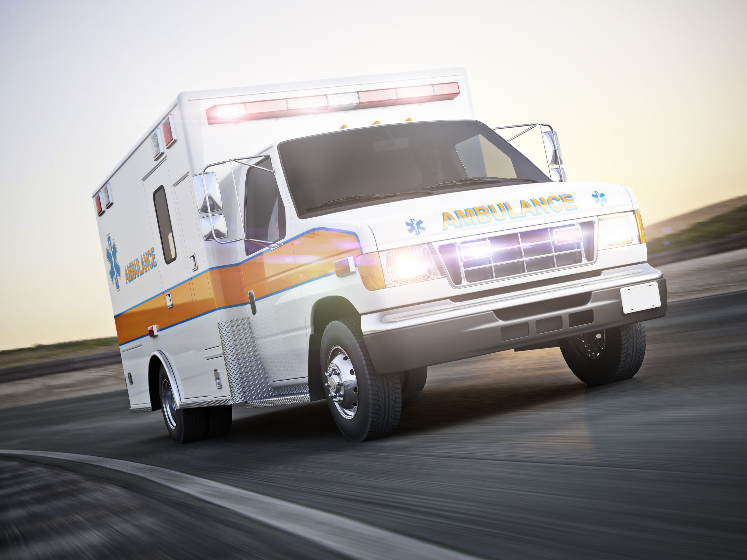 Ambulance running with lights and sirens on a street with motion