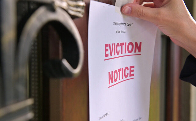 Close up Of A Tenants Eviction Notice Gluing To The Door