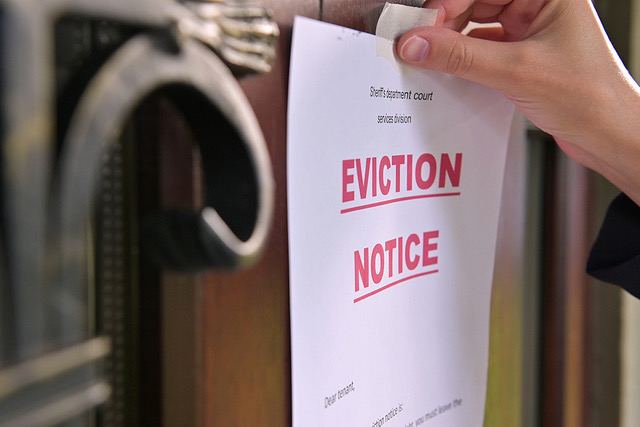 Close up Of A Tenants Eviction Notice Gluing To The Door
